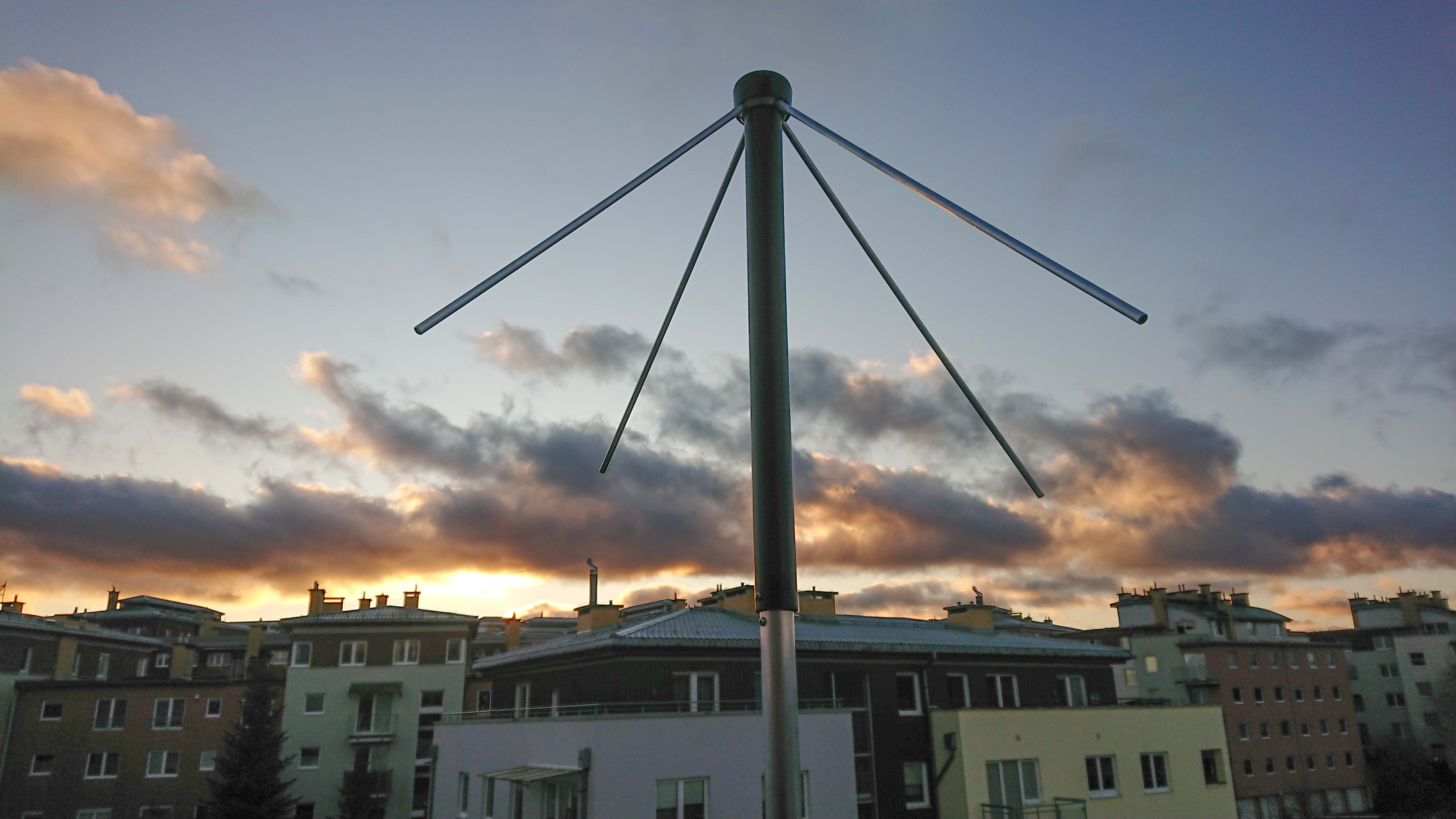 The second (v2) antenna used. It is a crossed dipole antenna produced by WiMo. The type is TA-1. It was used since 2019 till late 2021, when it was replaced by QFH. Optimized for 137MHz. The reception was OK, but it fluctuated over time. The antenna was a bit hard to assemble. One of the two horizontal reflectors (crossed pipes at the bottom) was stuck during initial assembly attempt and had to be cut, so was slightly shorter (102cm rather than 106cm). Not sure if that affected the reception. The antenna was not insulated from the balcony railing that circumvented the whole building. Perhaps that had and impact. Anyway, reasonably good first antenna.